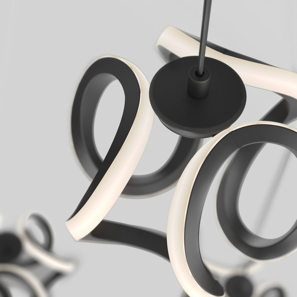 Close-up of Artika’s Vivaldi LED 4-light pendant, featuring curved black and white loops, set against a light gray background.