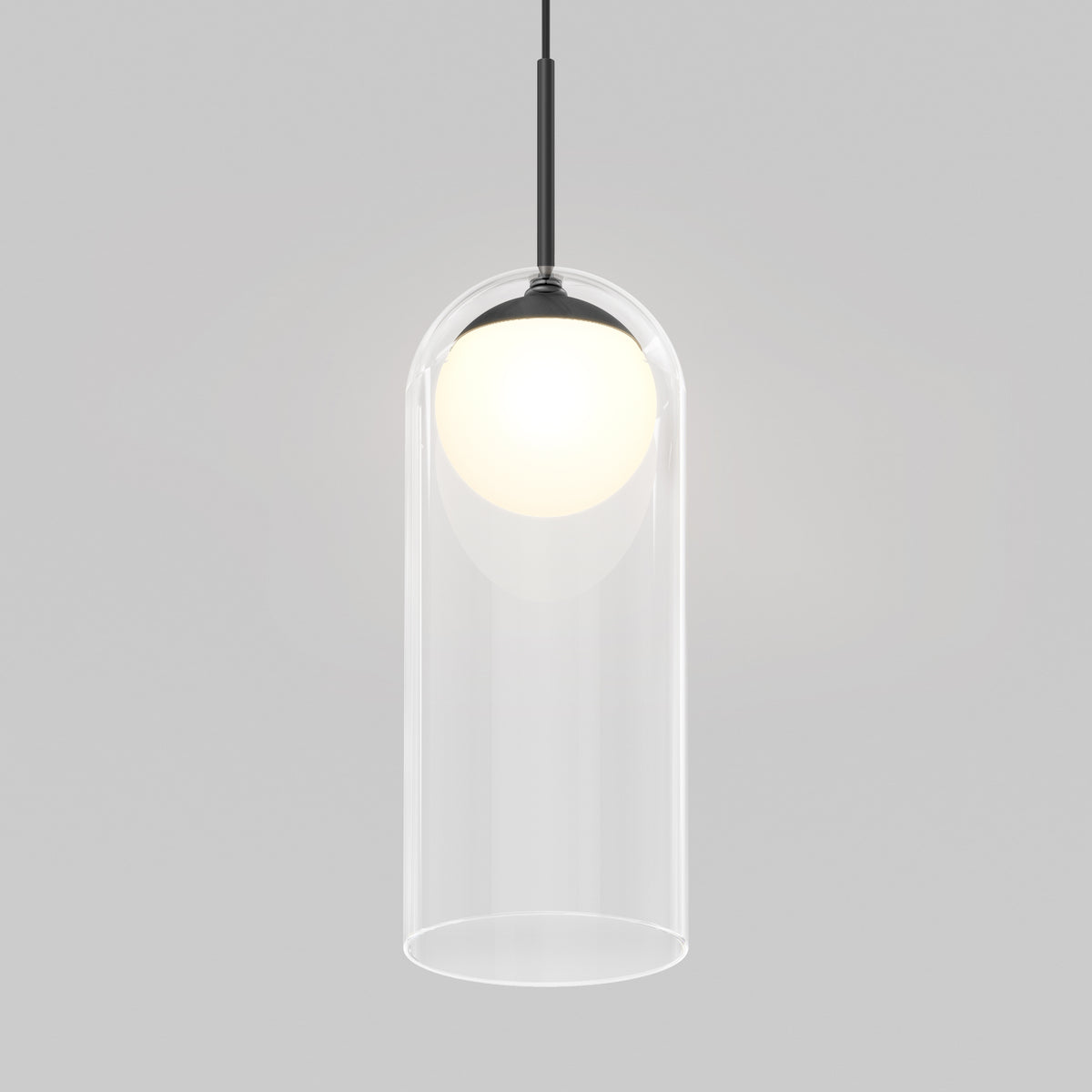 The Artika Mirah LED modern mid-century pendant light 3 CCT features a clear cylindrical glass shade with a glowing white bulb, suspended by a black cord against a light gray background.