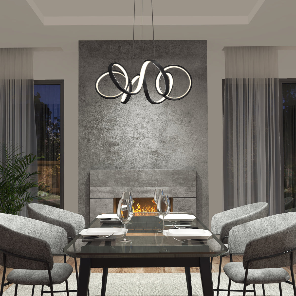 Modern dining room with a glass table for four, gray upholstered chairs, sheer curtains, a lit fireplace against a concrete accent wall, and the Artika Swirl Ribbon LED pendant light as a contemporary centerpiece.