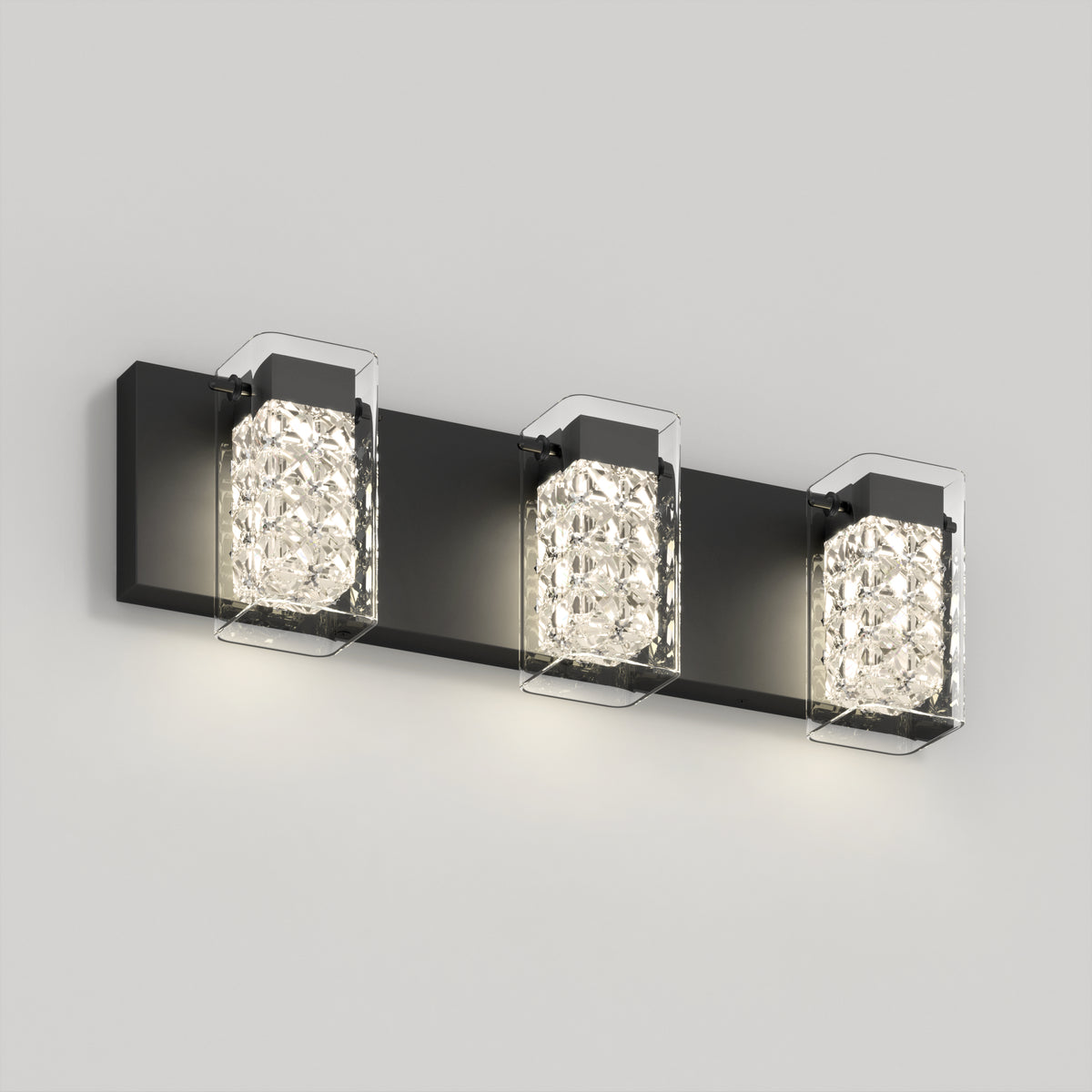 The Artika Crystal Cube LED bathroom vanity light 5 CCT features a black rectangular base and three crystal-like square glass shades, each housing a glowing bulb, elegantly mounted on a light gray wall.