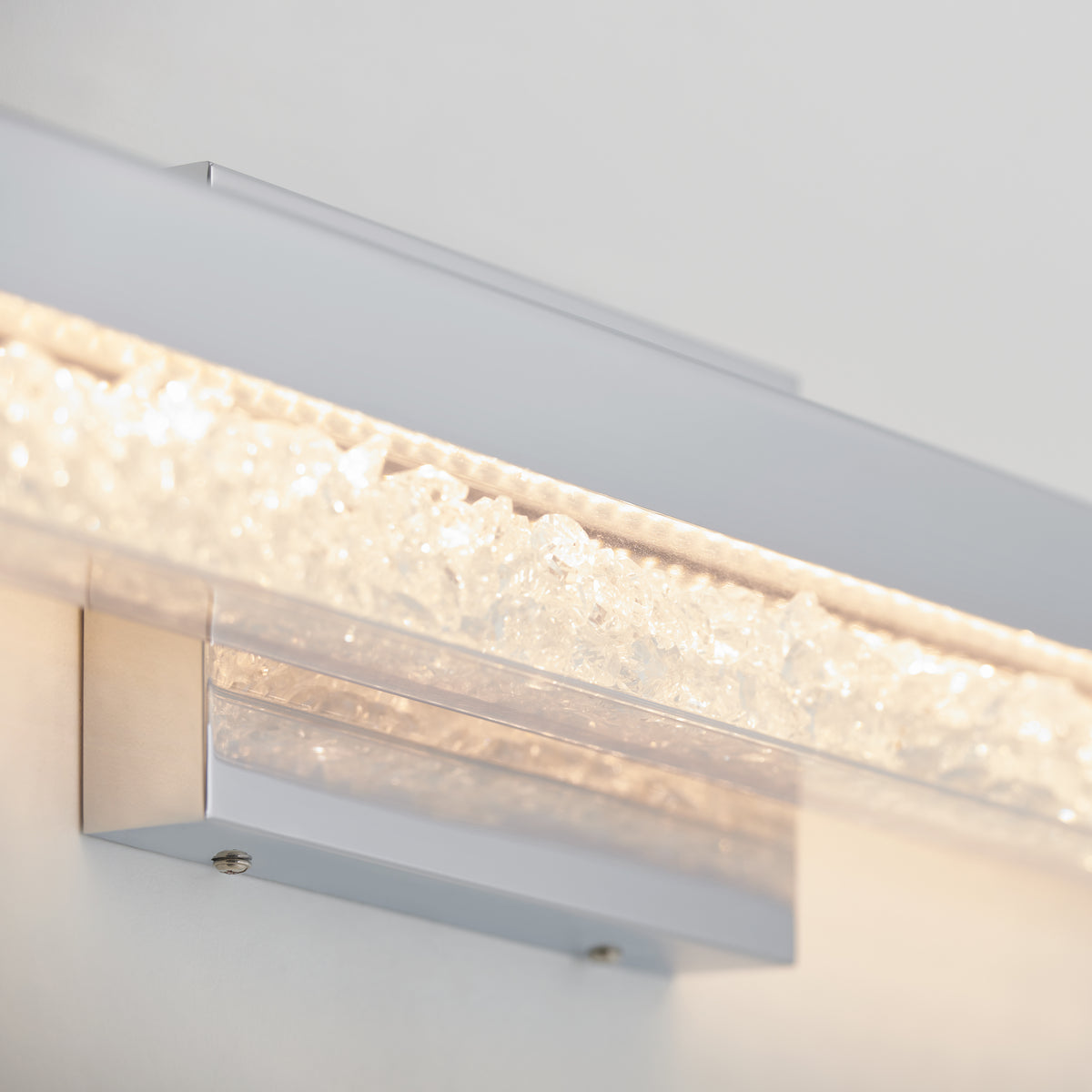 Close-up of Artika Riviera 27-in LED Vanity Light Bar, wall-mounted, featuring a textured crystal-like glowing strip.