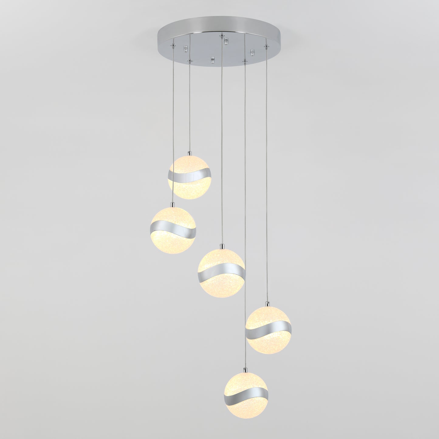 The Artika Wavey 5-light LED pendant features five frosted glass globes with silver bands, suspended at varied heights from a round, silver base for a striking modern look.