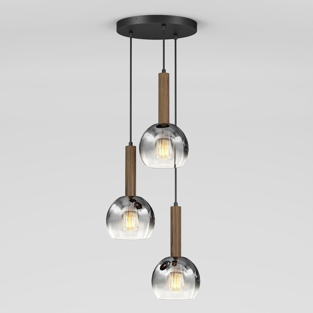 The Ardel Spiral 3-Light Pendant by Artika features three clear glass globes suspended by black cords with wooden accents from a round black ceiling mount; bulbs not included.