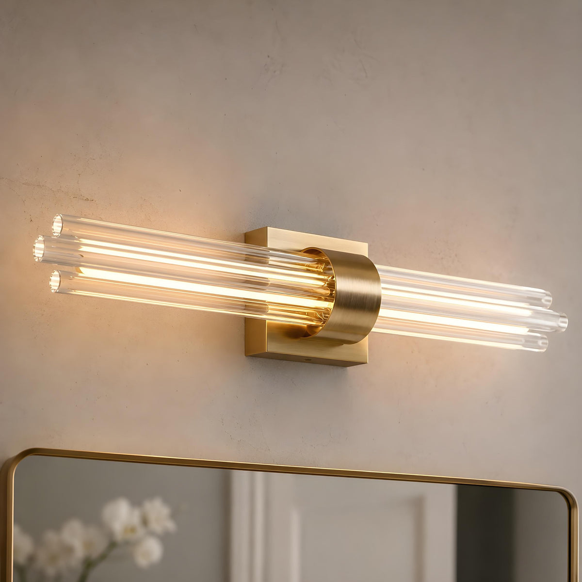 Artika Dorado 27 in. LED Wall Vanity features dimmable lighting, brass base, and glass rods—perfect above a mirror on light beige walls.