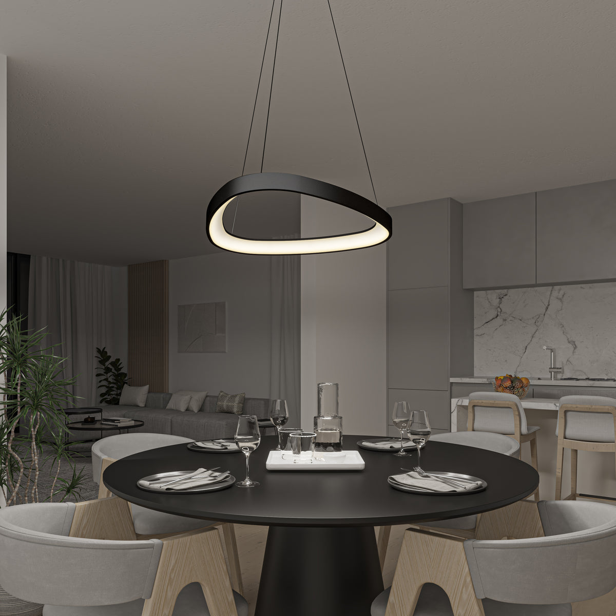A modern dining area with a round black table for four sits beneath the Artika Bjorn modern LED pendant light 5 CCT. The space has minimalist decor, light wood chairs, and an open kitchen in the background.