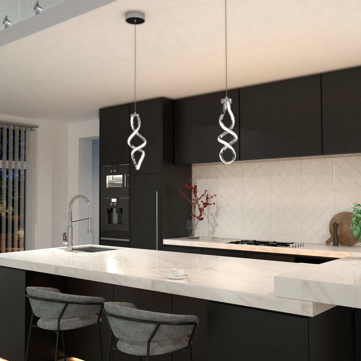 Modern kitchen featuring black cabinets, white marble countertops, two gray cushioned bar stools, built-in appliances, a white herringbone backsplash, and an Artika Mini Swirl LED pendant light. A vase with branches decorates the counter.