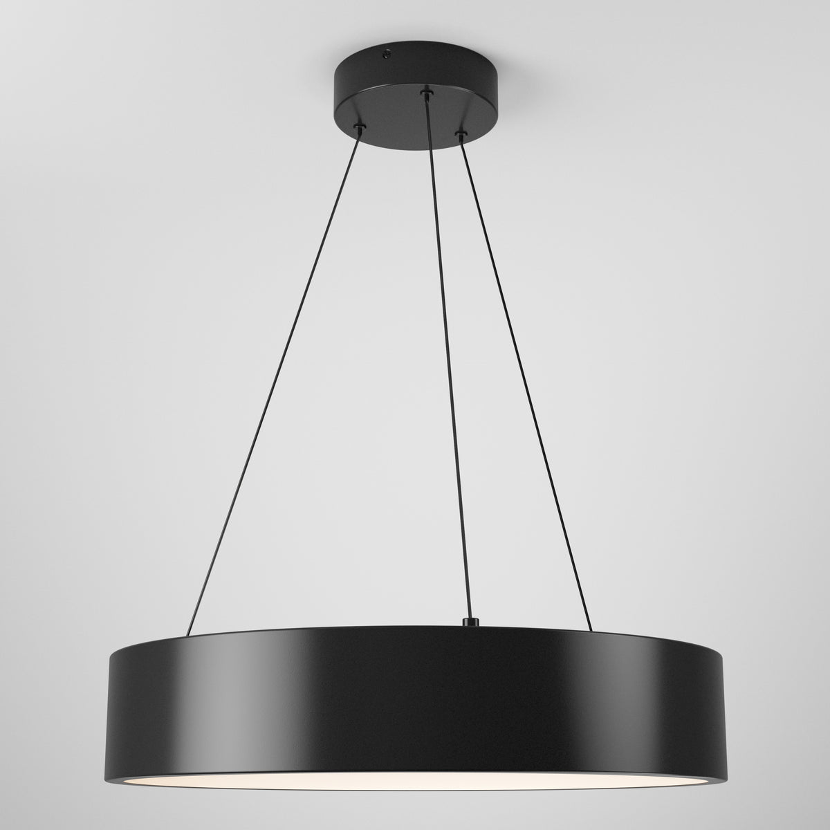 The Artika Aiden LED pendant light features a modern black circular design with thin suspension wires, hanging from a white ceiling and casting soft, diffused light from below.