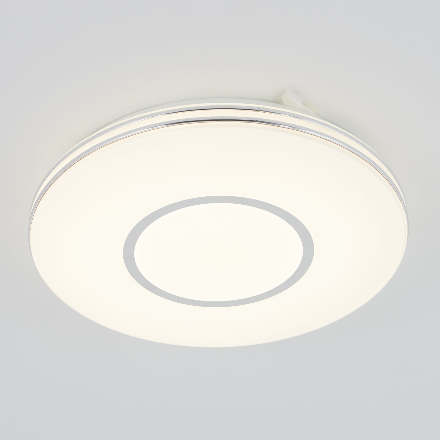 The Artika Horizon 13 in. LED flush mount light 3 CCT features a modern circular design with a white frosted cover and minimalistic ring, shown mounted on a plain white ceiling.