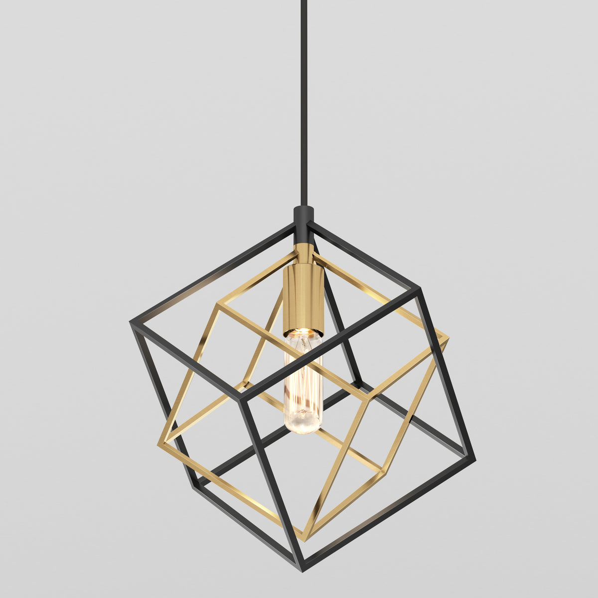The Artika Imperium Single pendant light features a modern, geometric black and gold cube-shaped metal frame with an exposed bulb, suspended from a black cord against a plain gray background.