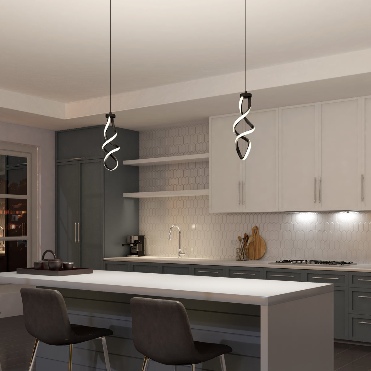 Modern kitchen with white cabinets, hex tile backsplash, and an island with two gray chairs. Above the island hang two Artika Mini Swirl LED pendant lights. Shelves and kitchen items add decorative touches to the space.
