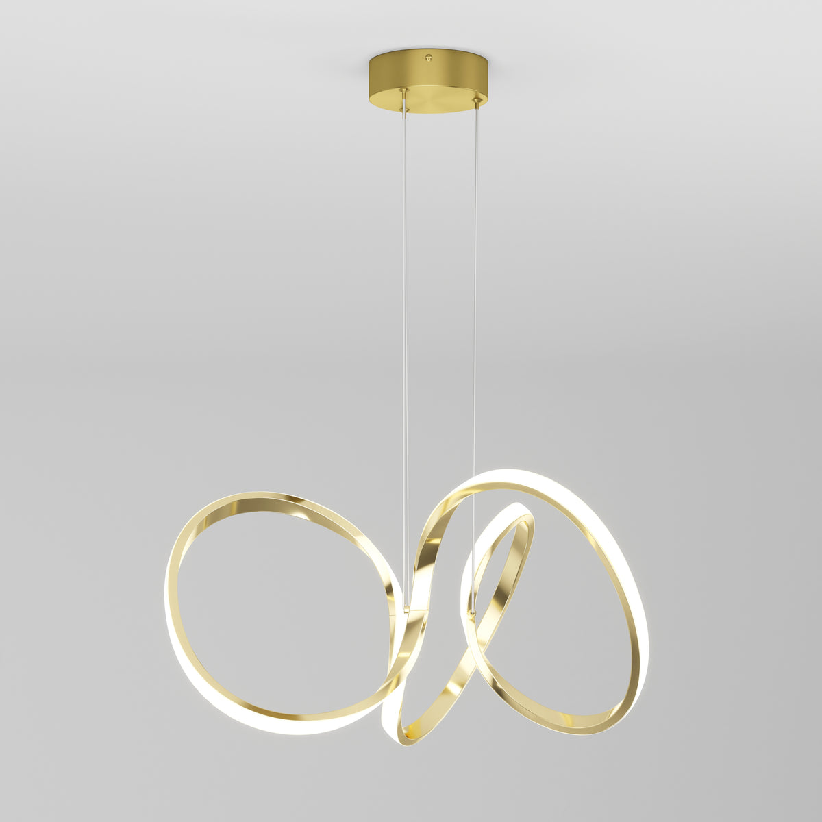 The Artika Swirl LED pendant light features two interlocking, illuminated loops suspended by thin cables from a round gold mount, shown against a plain white background.