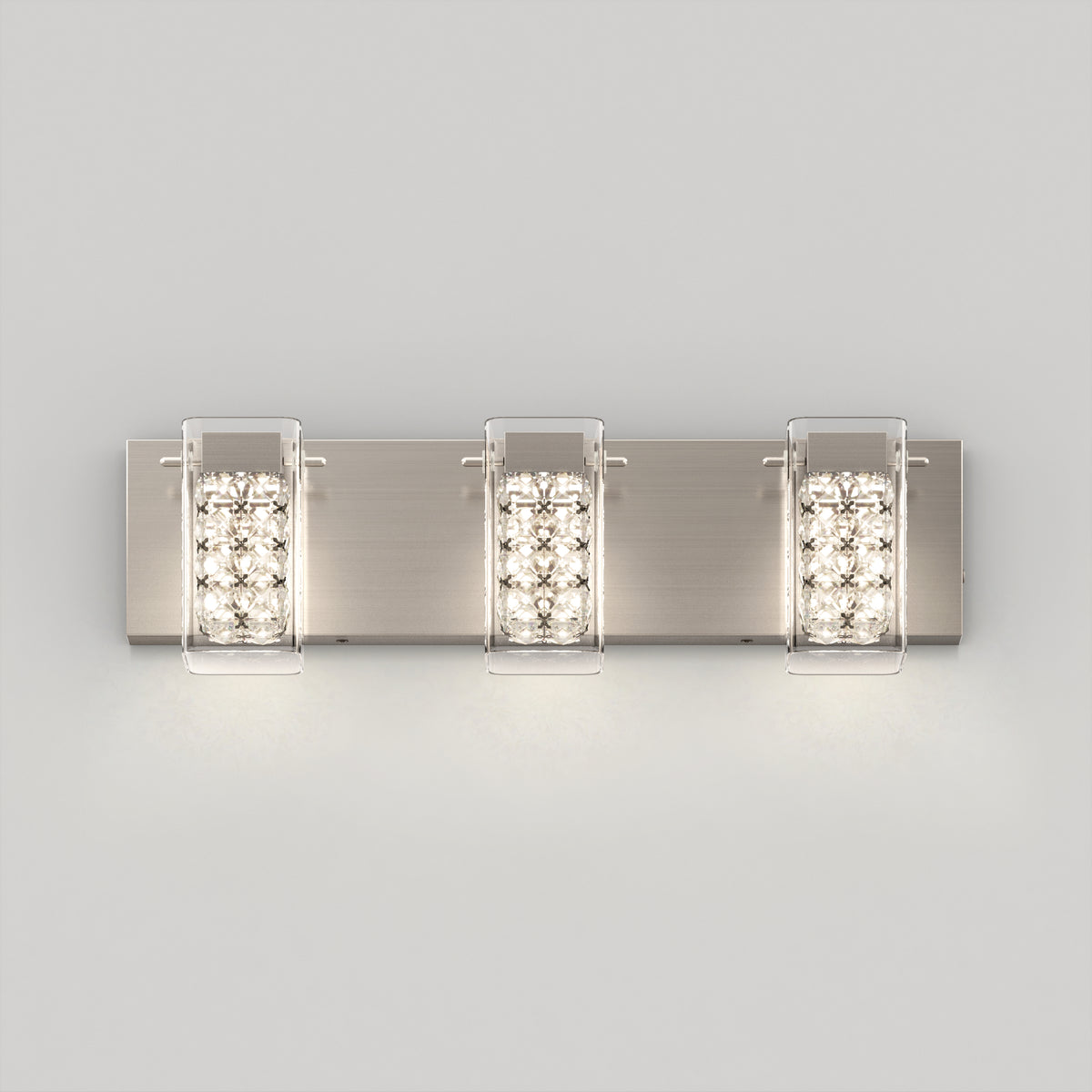 The Artika Crystal Cube LED bathroom vanity light 5 CCT is a modern wall-mounted fixture with three rectangular lights on a brushed metal plate, each encased in clear panels and featuring crystal-style accents for a soft, bright glow.