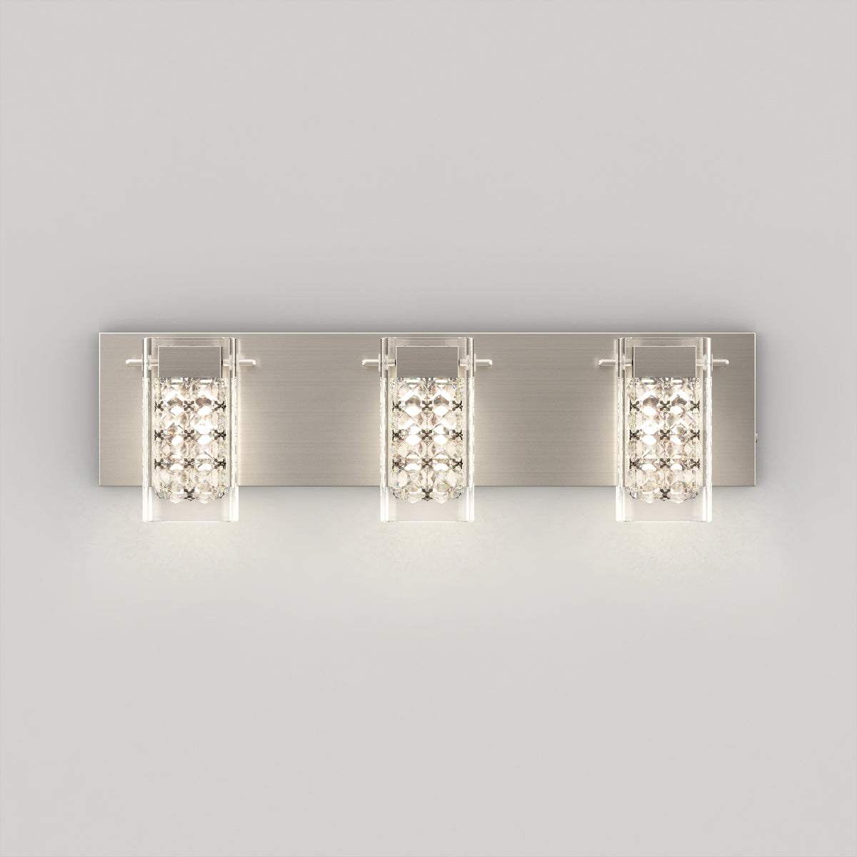 The Artika Crystal Cube LED bathroom vanity light 5 CCT features three rectangular lights with glass panels and sparkling crystal accents, mounted on a brushed metal backplate and displayed against a plain light gray background.