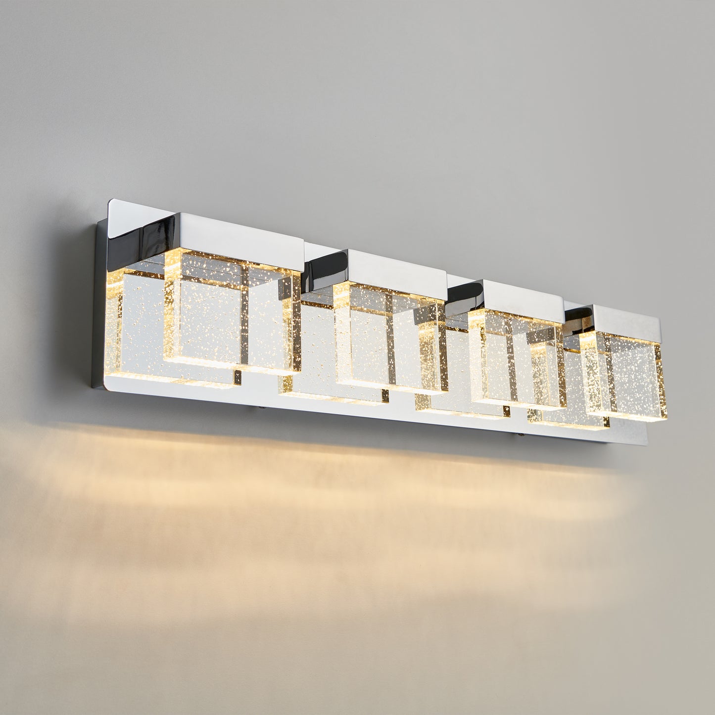 The Artika Bubble Cube 4-light LED bathroom vanity light features four bubbled square glass shades on a sleek chrome base, wall-mounted for a modern look.