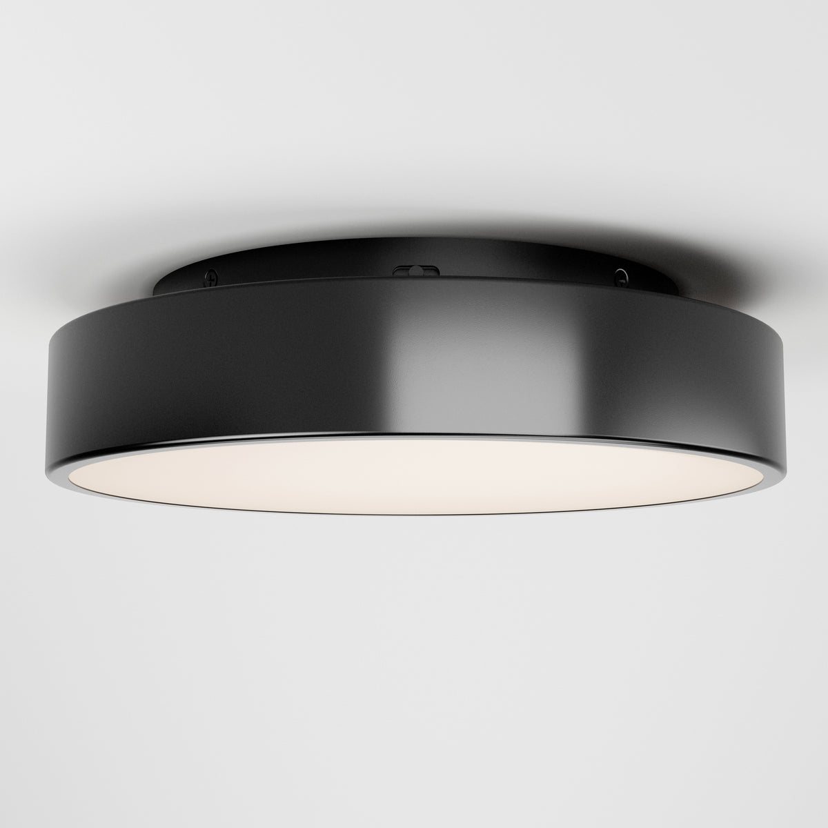 The Artika Aiden LED flush mount is a modern, round black ceiling light with a smooth finish and white diffuser, shown installed on a plain white ceiling.