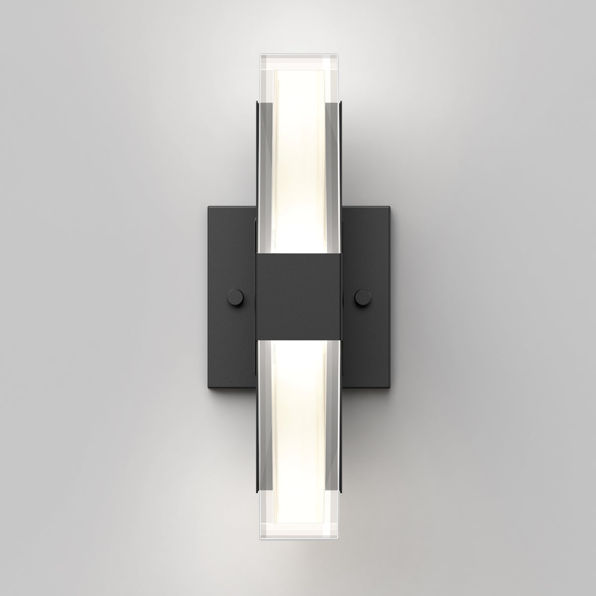 The Artika Gemini indoor-outdoor LED wall light features a rectangular black base and two horizontal frosted glass diffusers, creating a soft white glow on a light gray wall.
