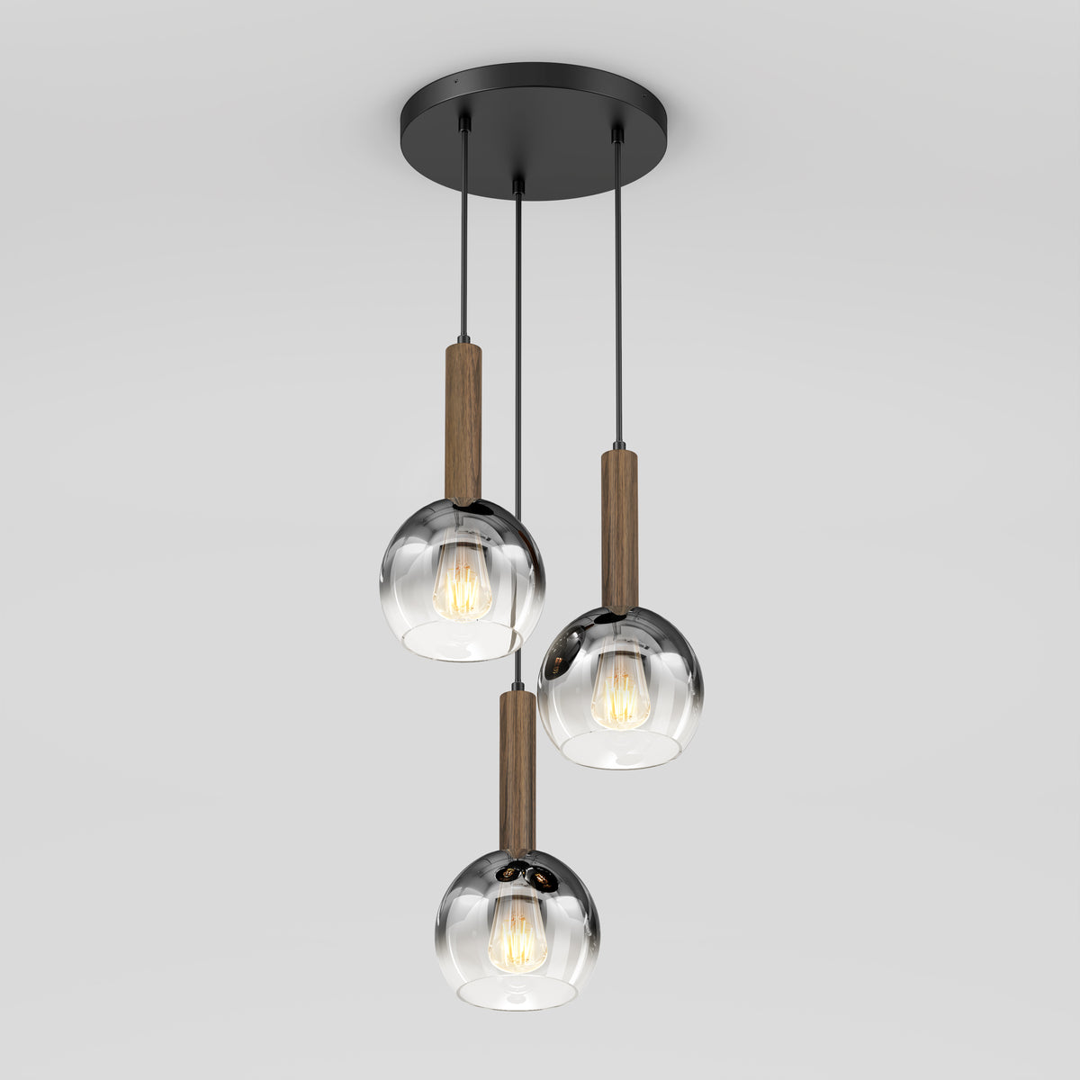 The Ardel Spiral 3-Light Pendant by Artika features three clear glass globes suspended by black cords with wood accents on a round black base. Bulbs not included.