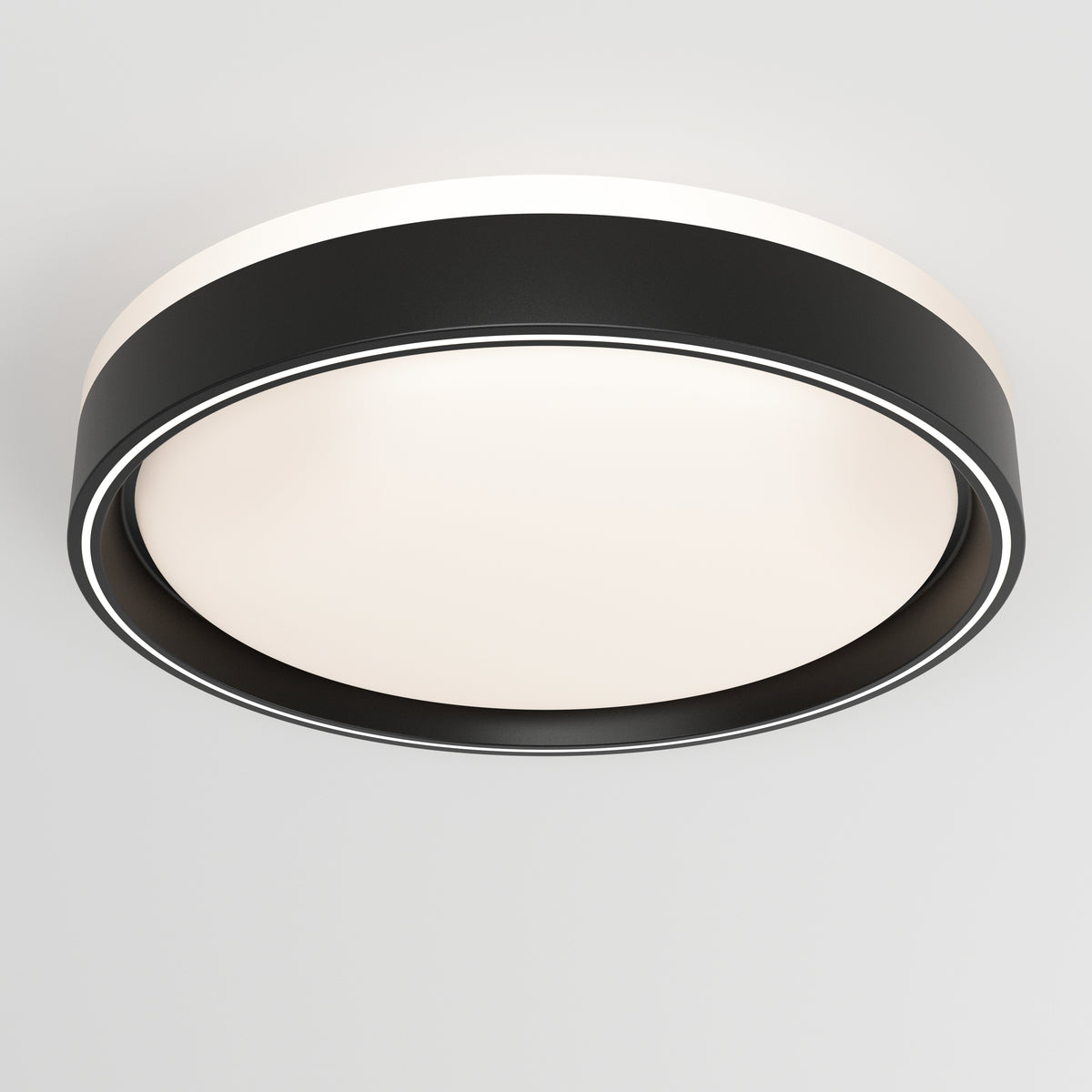 The Artika Callisto 15 in. LED flush mount light features a black outer ring and a white diffused center, creating a modern circular design when mounted on a plain white ceiling.