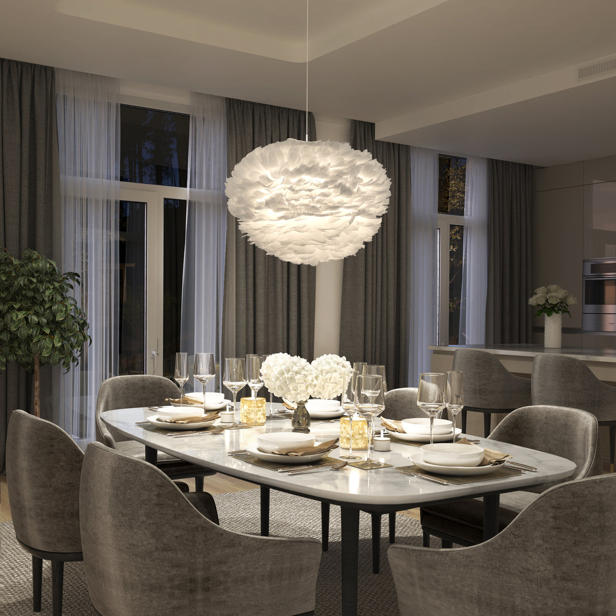 A modern dining room features a marble table for six, gray upholstered chairs, elegant place settings, large windows with sheer curtains, and a Plume LED pendant light by Artika above white flowers at the center of the table.