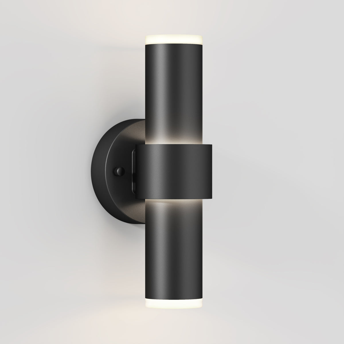 The Artika Dani modern LED indoor-outdoor wall light 5 CCT is a sleek, cylindrical black sconce with up-and-down lighting, mounted on a round base against a white wall.