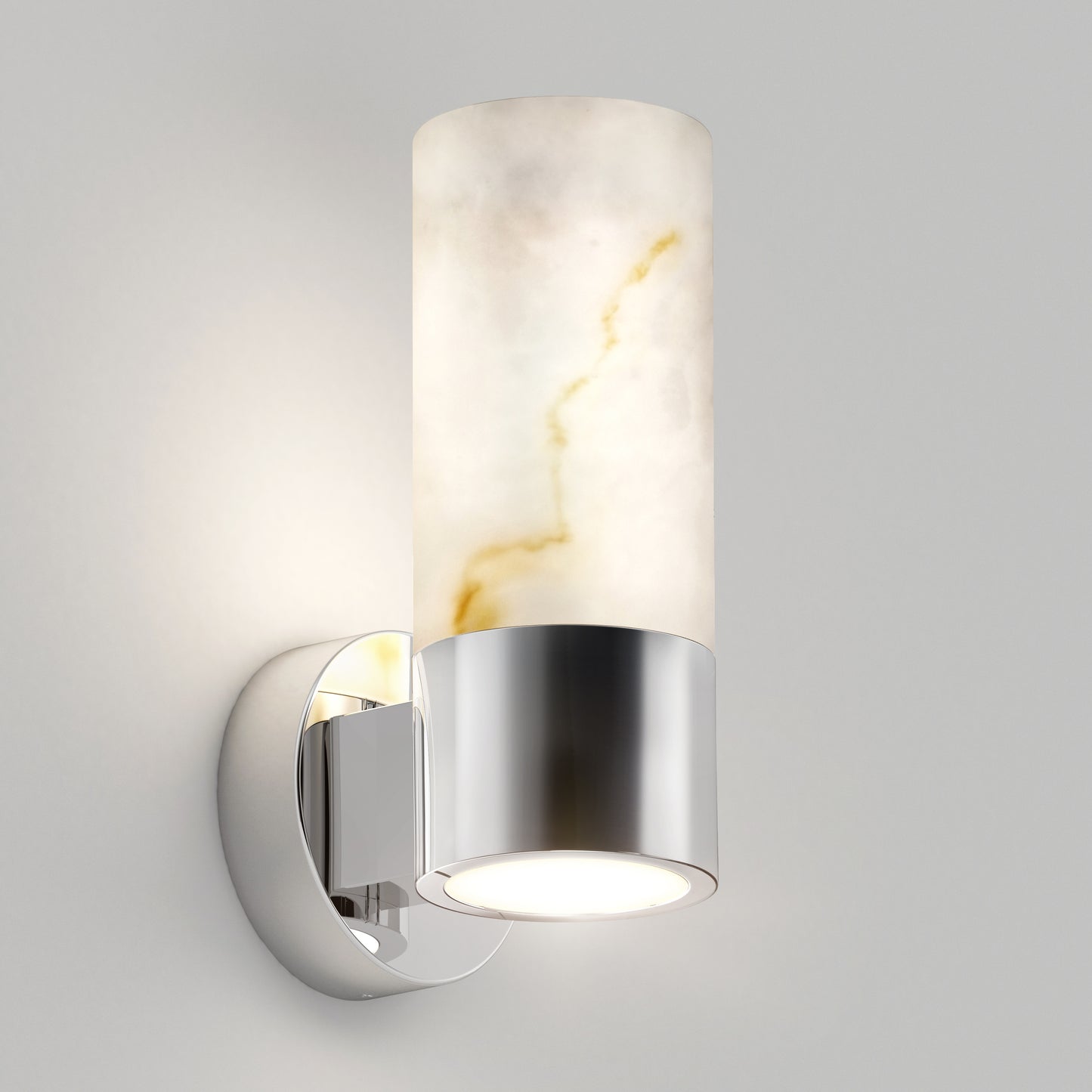 The Artika Marble LED contemporary sconce features a cylindrical white marble-like shade with gold veining, a chrome base, and emits downward light, adding a modern touch to any light gray wall.
