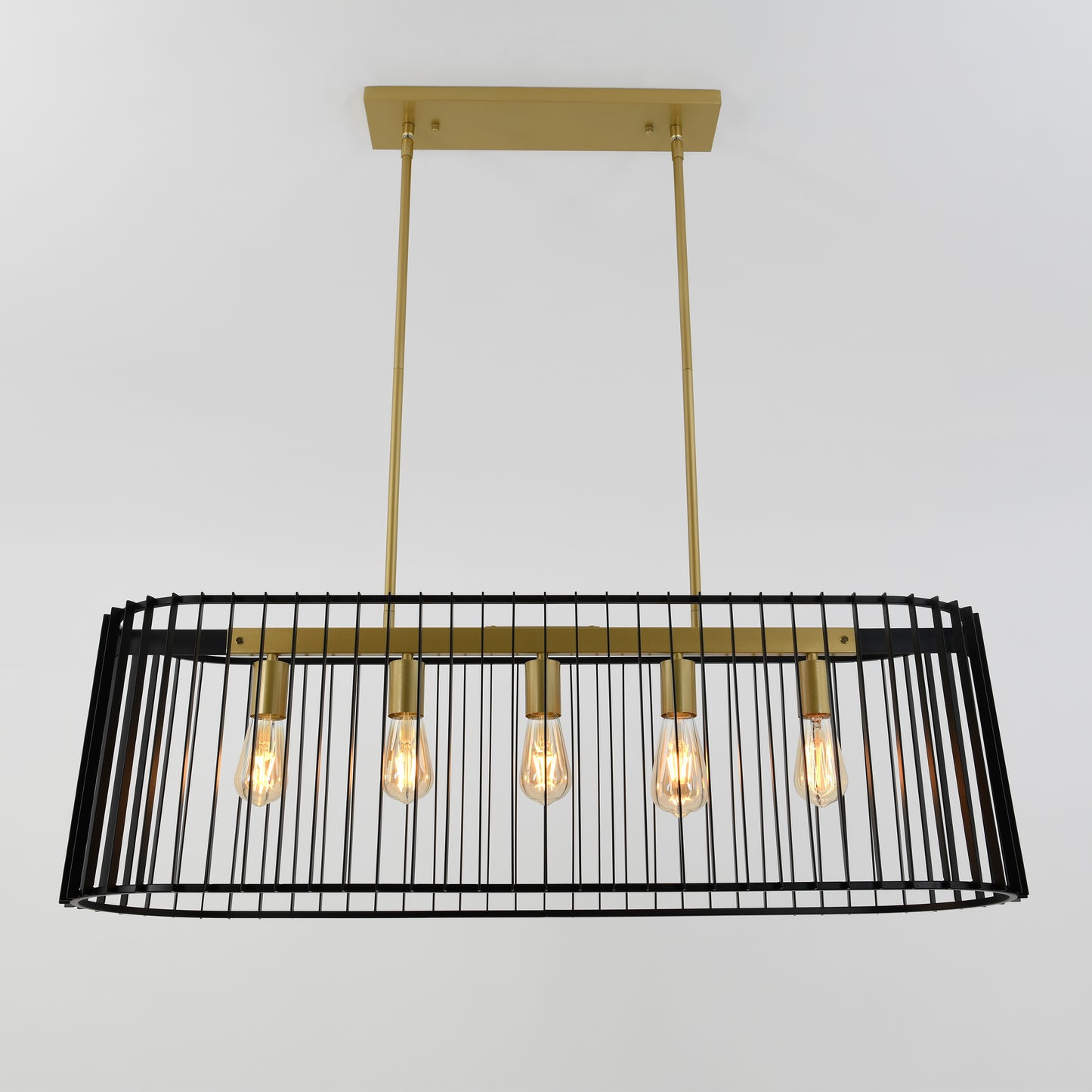The Artika Gatsby pendant light features a rectangular black metal cage frame with five exposed bulbs, gold rods and mount, suspended from a white ceiling.