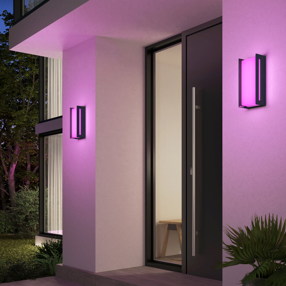 A modern entrance features two Artika Ryker smart RGB indoor-outdoor wall lights glowing pink on white walls beside a glass door. A bench is visible inside, with plants in the foreground.