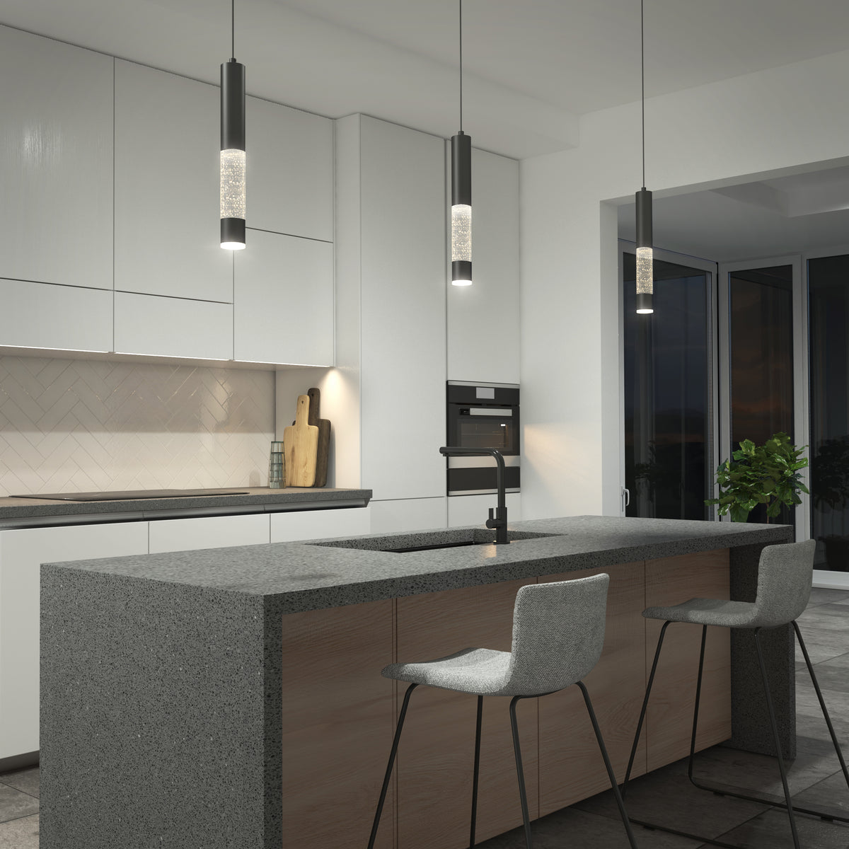 Modern kitchen with a gray stone island, two bar stools, built-in cabinets, a built-in oven, a sink with a black faucet, a plant near large windows, and Mist LED pendant lights by Artika hanging above.