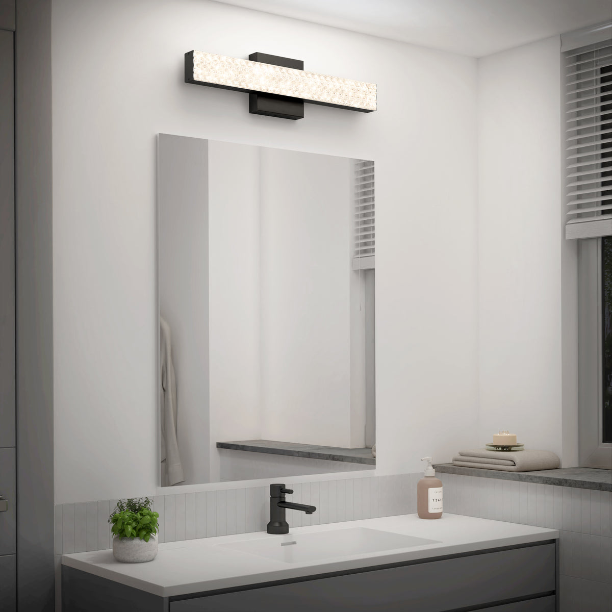 Modern bathroom with a rectangular mirror, black faucet, potted plant, and Artika Adeline modern LED vanity light 3 CCT.