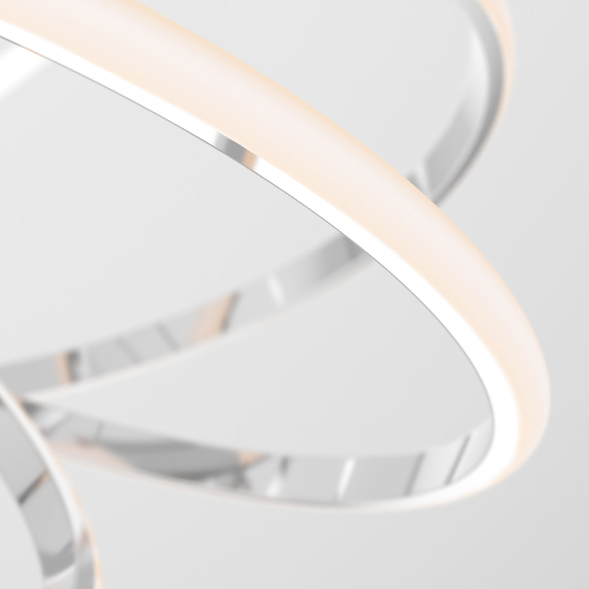 Close-up of Artikas Maelstrom modern LED pendant light 5 CCT: sleek, intertwined metallic and glowing strips form an abstract, minimalistic design against a plain white background.