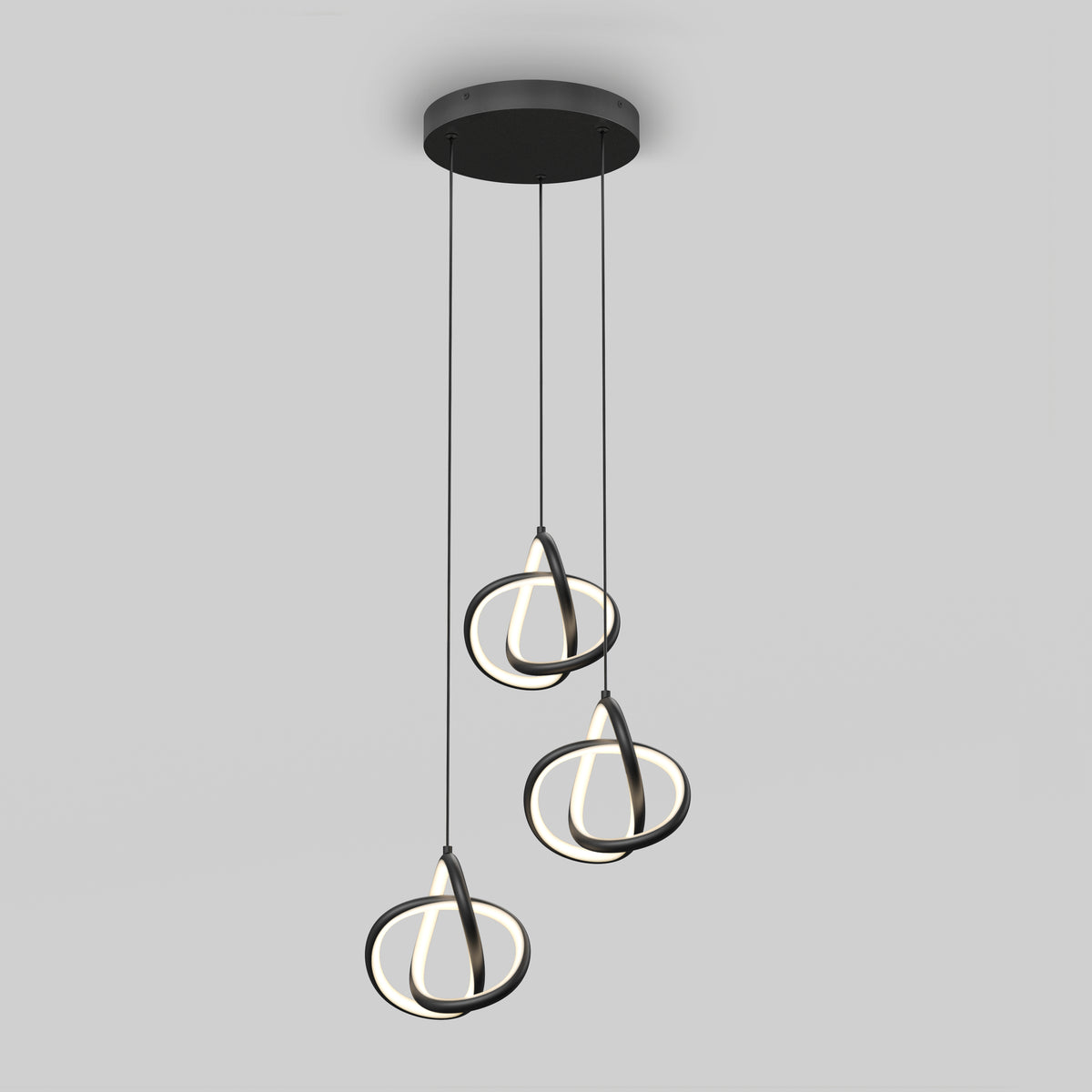 The Artika Zephyr 3-light LED pendant features three circular LED rings suspended by black cords from a round black ceiling mount, creating a modern look against a plain gray background.