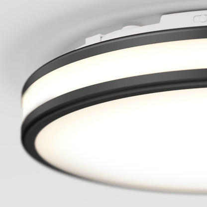 Close-up of the Artika Hemisphere 15 in. LED flush mount light with a black and white design, featuring 5 CCT adjustable brightness for perfect ambiance on a plain, light-colored ceiling.