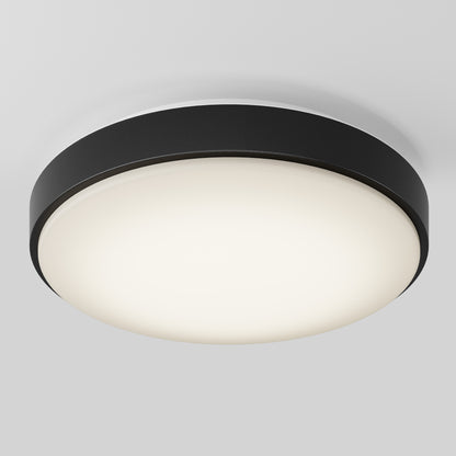 The Artika Sunraker 10 in. LED modern flush mount light features a round black outer rim and frosted white diffuser, seamlessly mounted on a white ceiling.