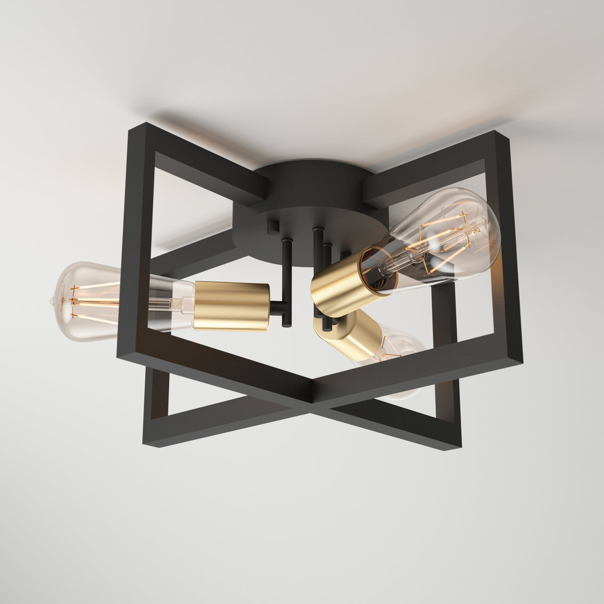 The Artika Holt 3-light flush mount features a matte black geometric metal frame with gold accents and three exposed Edison-style bulbs, stylishly mounted on a white ceiling.