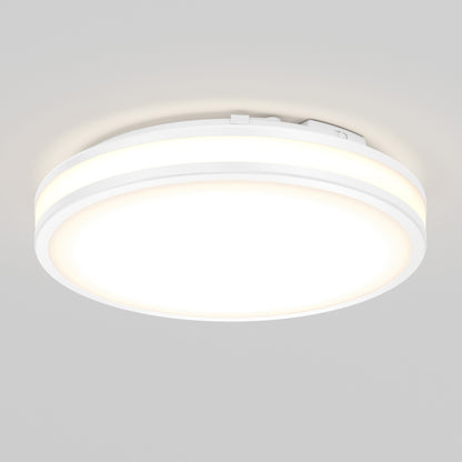 The Artika Hemisphere 15 in. LED flush mount light features a round, white design with a glowing center and thin illuminated edge, and is mounted on a plain light gray ceiling.