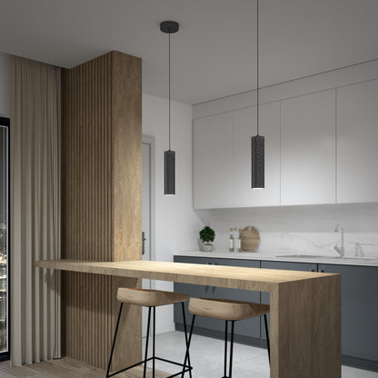 Modern kitchen with light wood and white cabinetry, marble backsplash, two Artika Cosmic modern LED pendant lights (3 CCT), a wooden breakfast bar with two stools, and neutral-toned curtains covering the window.