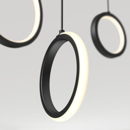 The Artika Elmo 5-light LED pendant features modern circular black frames with glowing white edges, suspended against a light grey background. Its minimal, contemporary design offers versatile style with 5 CCT settings.