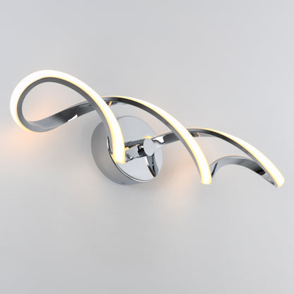 The Swirl modern LED bathroom vanity light by Artika features two intertwined chrome arms on a circular base, emitting a soft white glow—ideal for adding elegant, modern style to any space.