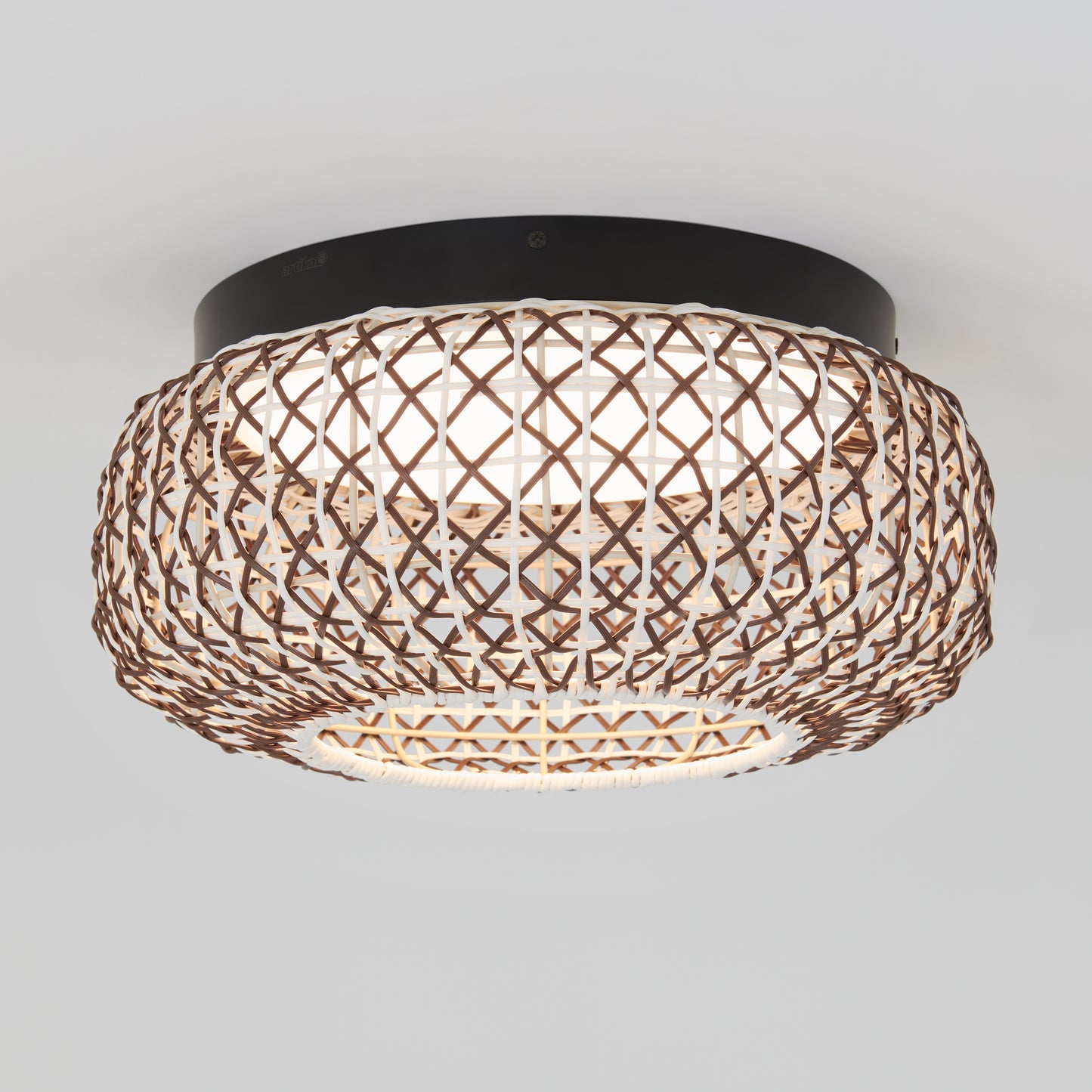 The Artika Benson 15 in. LED flush mount light features a round, crisscross-patterned woven rattan shade, a black base, and offers soft, diffused lighting with 5 selectable color temperatures.