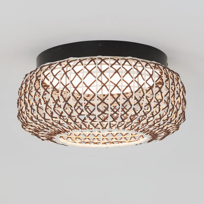 The Artika Benson 15 in. LED flush mount light features a round, crisscross-patterned woven rattan shade, a black base, and offers soft, diffused lighting with 5 selectable color temperatures.
