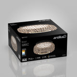A black box featuring a Benson LED ceiling light by Artika, showing an image of the light with a woven, metallic design. The box displays product specs, energy ratings, and the brand logo on multiple sides.