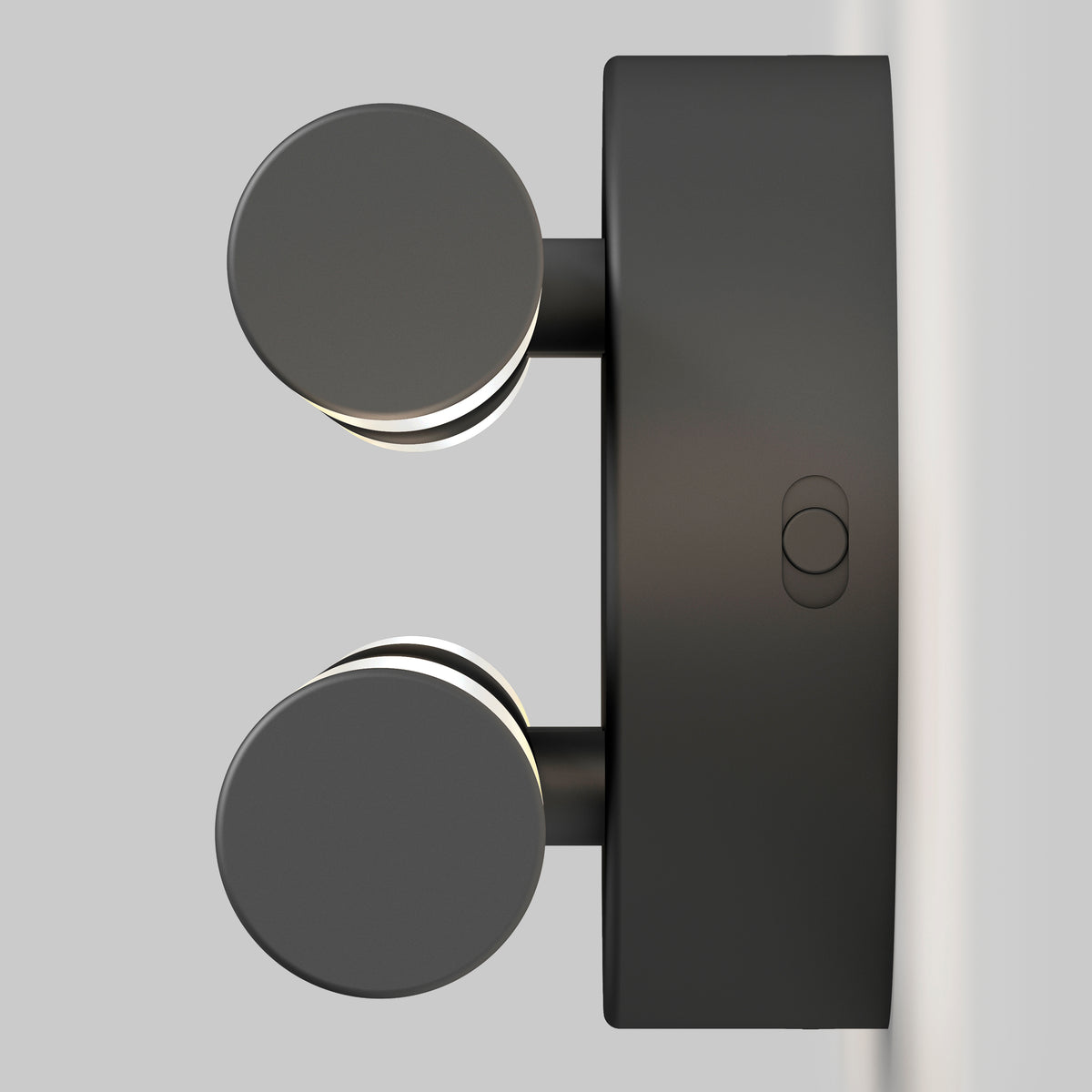 A modern black wall-mounted light fixture with two round, disc-shaped lights extending outward, attached to a rectangular base against a plain light gray background.