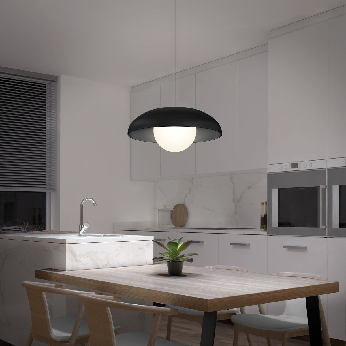 Modern kitchen with white cabinets, marble backsplash, and built-in appliances. A round wooden table with four chairs sits beneath a large, dome-shaped black pendant light, and a potted plant is centered on the table.