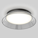 A modern round ceiling light fixture with a black base, wide frosted glass cover, and a clear outer rim, emitting a soft white glow against a light gray background.