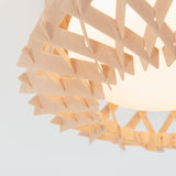 Close-up of a light fixture with a geometric, wooden lattice design around a frosted white bulb, set against a plain light background.