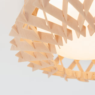 Close-up of the Artika Kiran 13 in. modern LED flush mount light, featuring a geometric wooden frame with interlocking triangles encasing a glowing bulb.