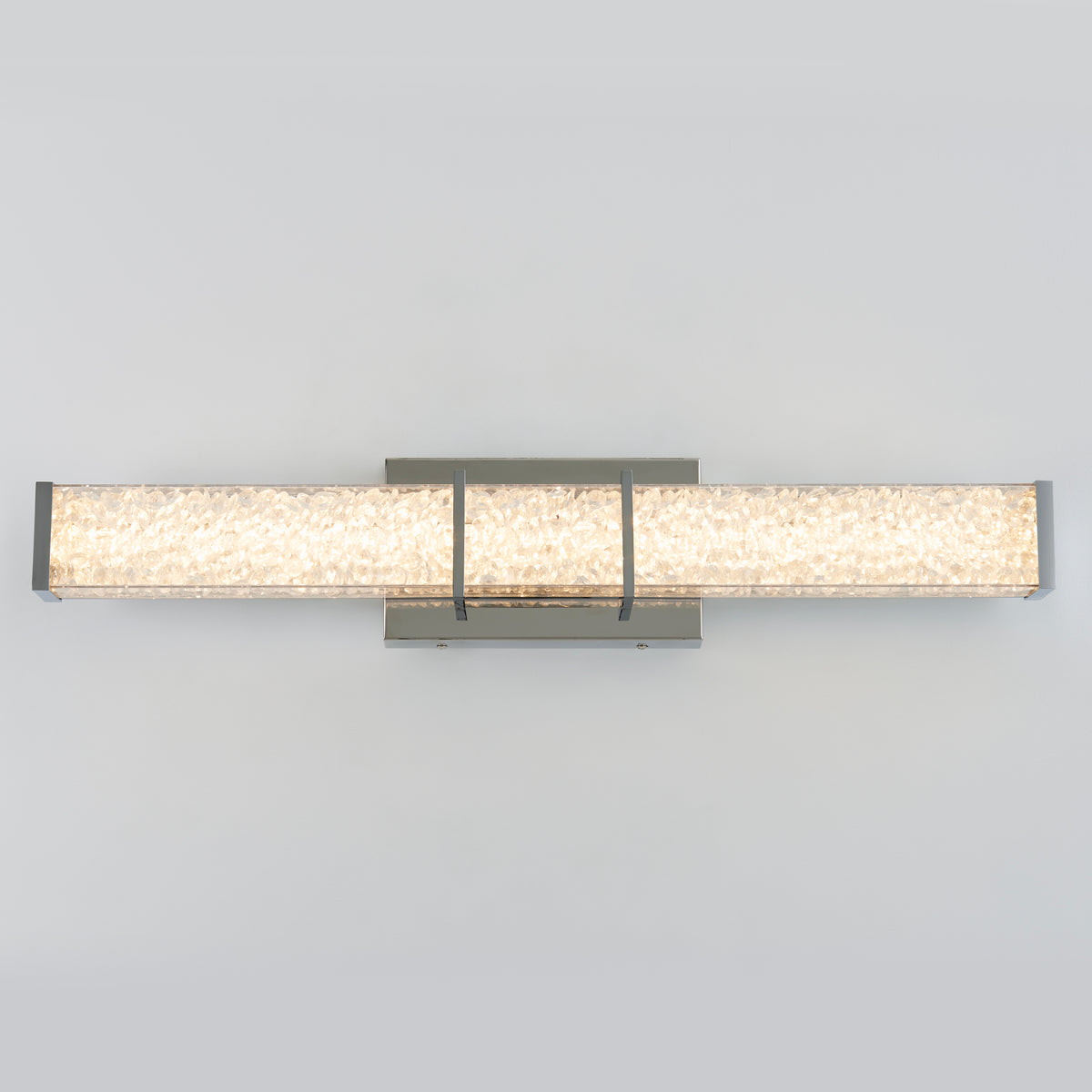 Rectangular modern wall sconce with a textured, illuminated glass or acrylic panel and metallic end caps, mounted on a matching rectangular backplate against a light gray background.