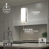 Modern kitchen pendant light with a chrome finish and silk skin glass diffuser hangs over a countertop. Features include adjustable height, integrated LED, and a 5-year warranty. No bulbs are required.