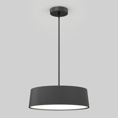 The Artika Groove Drum LED contemporary pendant light features a ribbed black cylindrical shade and hangs from a straight rod, casting soft white light against a plain light gray background.