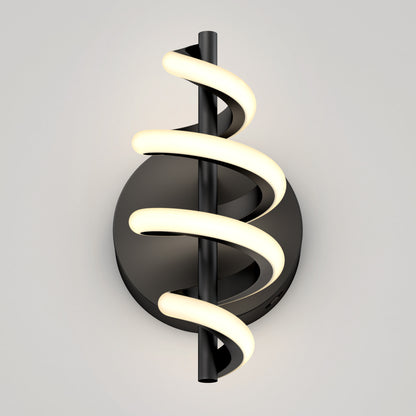 The Artika Chorus LED Wall Light features a modern black design with a round base, vertical rod, and glowing spiral LED, shown against a light gray background.
